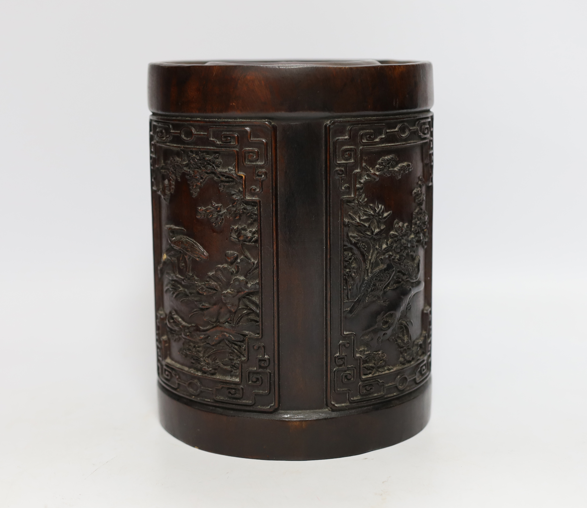 A heavy Chinese wooden brush pot decorated with birds, possibly Zitan, 20cm high